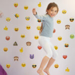 Emoji Wall Sticker Pack with girl jumping in bedroom